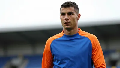 Colwyn Bay's Max McGoona has joined Mold on loan until January, aiming to help the team turn their fortunes around